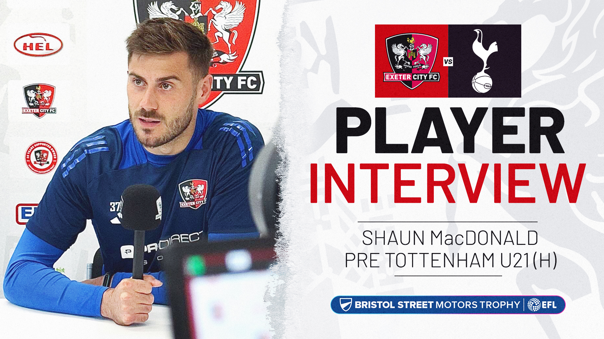 Player interview graphic. On the left is an image of Shaun MacDonald, wearing a blue goalkeeper training top, talking into a mic, on the left is text reading: PLAYER INTERVIEW / SHAUN MacDONALD PRE TOTTENHAM U21 (H). The Bristol Street Motors Trophy Logo is below the text.