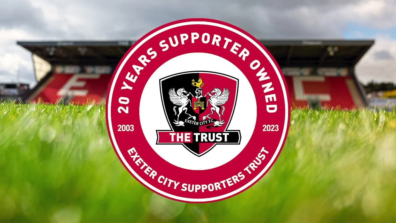 The ECFC Supporters' Trust logo on top of an image of the pitch and the Adam Stansfield Stand